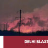 Emergency responders at a burning industrial facility at night