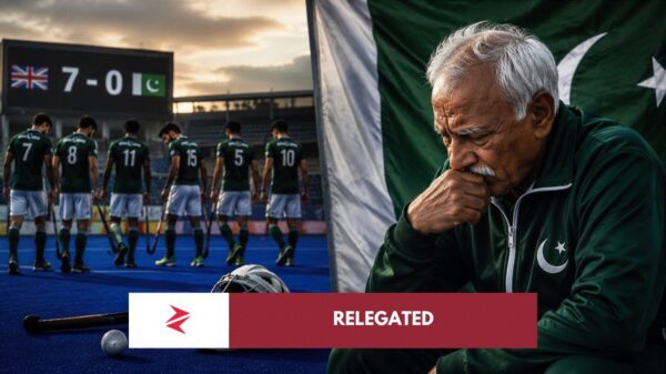 Pakistan hockey player challenging goalkeeper during FIH Pro League match on blue turf.