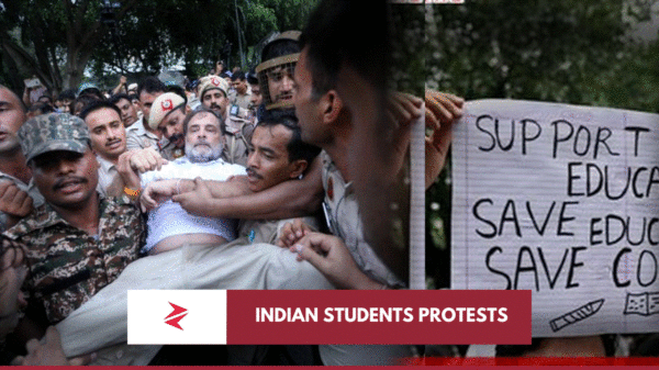 Indian security personnel carrying a detained protester beside a student placard during the July 2026 NEET demonstrations