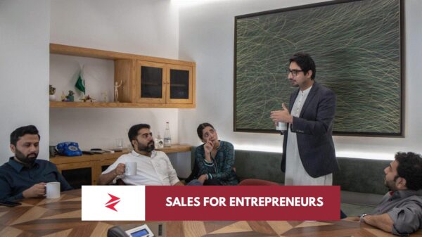 Pakistani entrepreneur using consultative sales skills during a client strategy meeting in Lahore