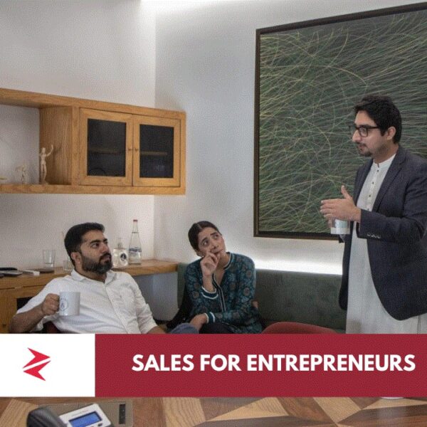 Pakistani entrepreneur using consultative sales skills during a client strategy meeting in Lahore