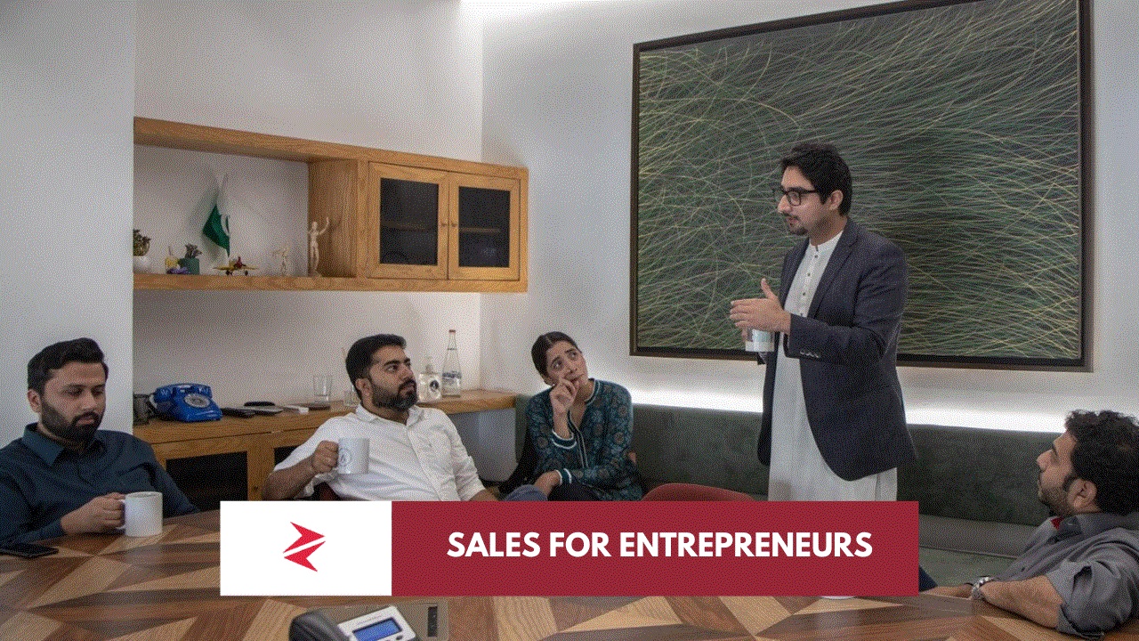 Pakistani entrepreneur using consultative sales skills during a client strategy meeting in Lahore