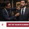 Pakistani master tailor fitting a charcoal suit at a premium bespoke tailoring shop in Islamabad