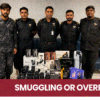 Pakistan Customs officers displaying undeclared cameras, lenses and a PS5 recovered at Karachi Airport