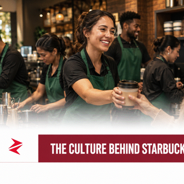 Starbucks corporate culture represented by baristas working together and serving a customer during a busy coffeehouse shift
