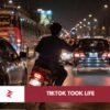 Reckless motorcyclist filming social media content while weaving through traffic in Lahore, Pakistan
