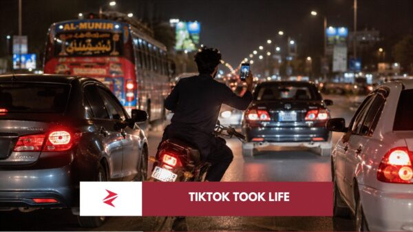 Reckless motorcyclist filming social media content while weaving through traffic in Lahore, Pakistan