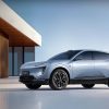Studio photograph of a light‑blue Avatr 07 electric SUV parked on a reflective surface in front of a modern architectural backdrop