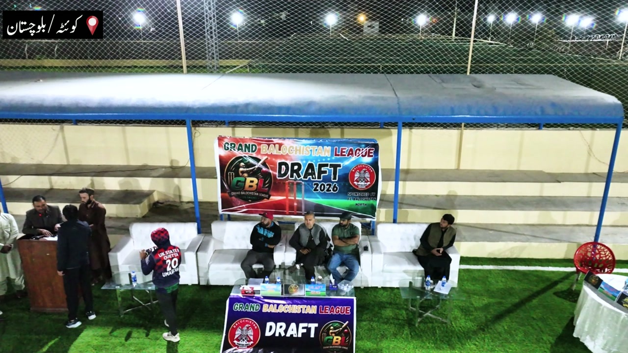 Night‑time outdoor draft event with men seated on sofas under a canopy, a large banner reading “GRAND BALOCHISTAN LEAGUE DRAFT 2026” and a location label “Quetta / Balochistan”