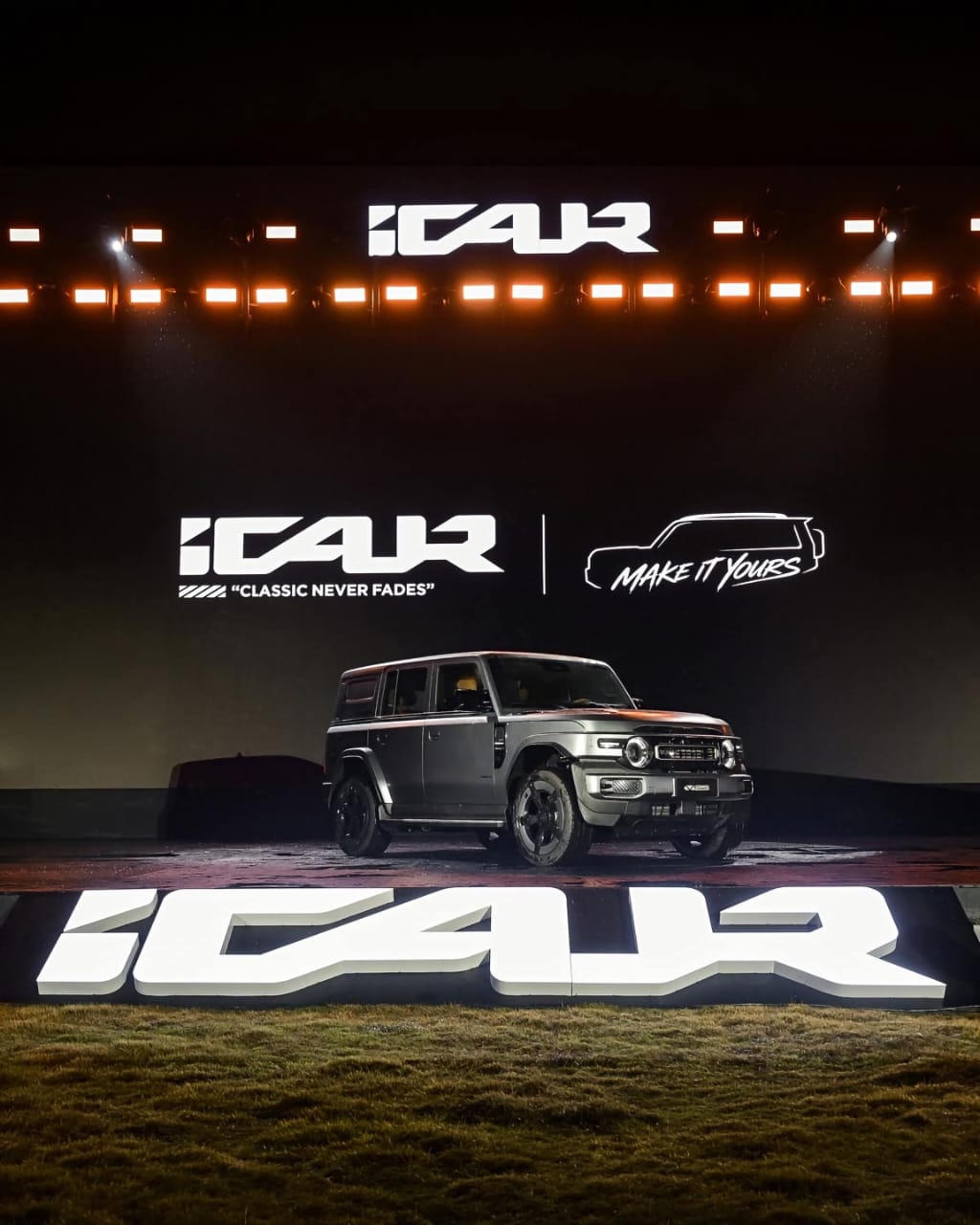 Promotional image of a silver boxy SUV on a stage with the iCAR logo and the slogan “CLASSIC NEVER FADES”